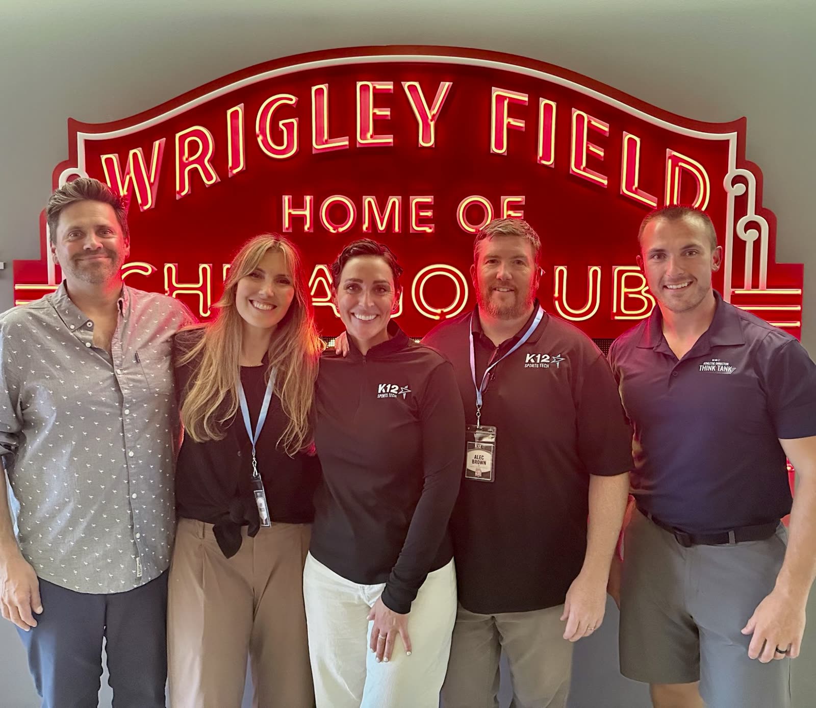 The K12 team in front of the Wrigley Field sign